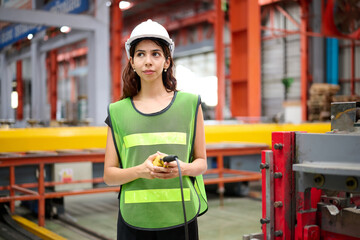 Engineer or worker operating remote switch to control machine in the factory