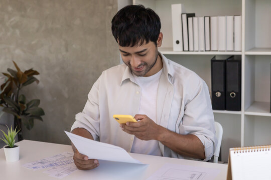 man use phone to scan barcode or QR codes to pay credit card bill after receiving document invoice online. payment, receive, paying electricity, digital payments without money, technology - Powered by Adobe