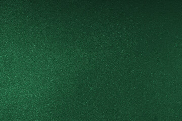 Abstract shiny, radiant texture background with different shades of dark green color. Painted canvas, glitter concrete surface, studio backdrop, grainy textured effect