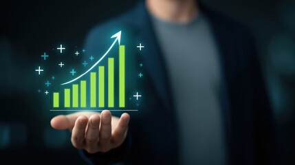 Business growth concept, man holding glowing green bar chart with upward arrow, symbolizing success, progress, and financial achievement in modern office environment