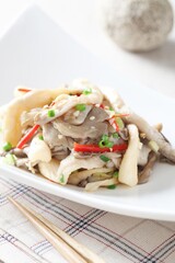 Close-up of oyster mushroom side dish with sesame seasoning, a wholesome Korean namul crafted by...