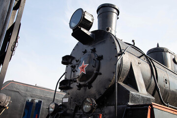 Chimney of a steam locomotive with a spotlight against the sky, an exhibition of old locomotives. Copy space for text