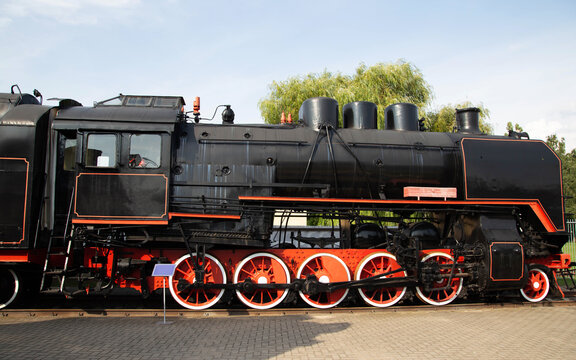 Black old steam locomotive at a museum exhibition, industry