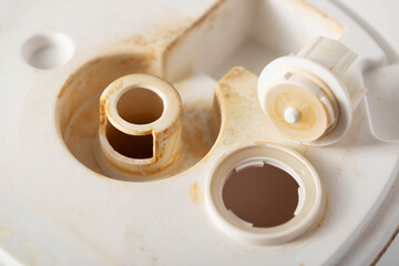 Unpleasant smell, rust and scale from water in the humidifier, white background, close-up