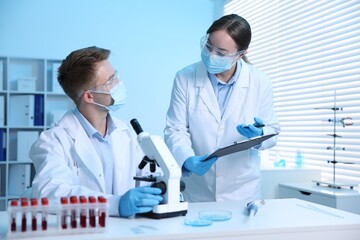 Medical analysis. Scientists working with microscope in laboratory