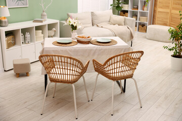 Stylish table with chairs and decor in dining room. Interior design