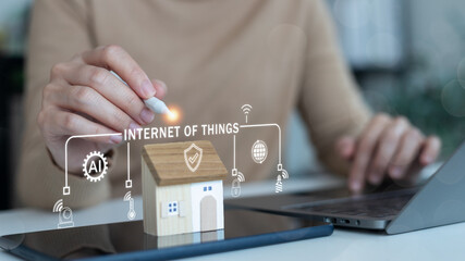 Smart home IoT technology with AI and cybersecurity concept. Hand using a stylus with digital icons, innovation in the Internet of Things for smart living.