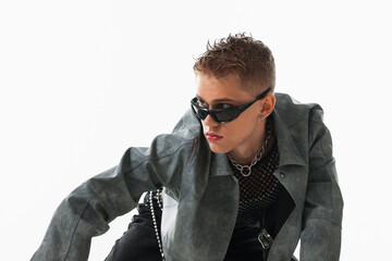 Obraz premium Handsome young man wearing stylish jacket and sunglasses on white background