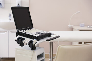 Modern ultrasound machine and examination bed in clinic