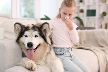 Girl suffering from allergy with her dog at home