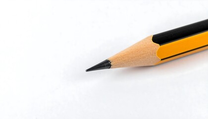 Close-up of a sharpened pencil point on a white surface.