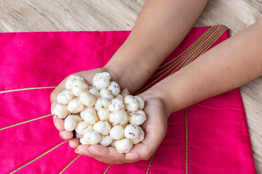 hand holding full of makhana or foxnuts. copy space for text