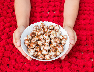 hand holding bowl full of healthy makhana dish for kids, travel or snack purpose. 
