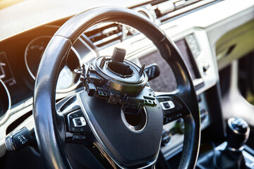 Broken steering column electrical cable of a car against the background of the car interior and...