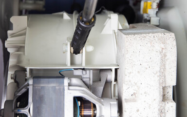 Broken shock absorbers in the washing machine. Concept for repair and replacement of shock...