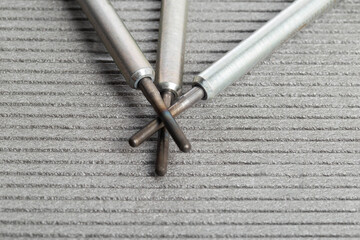 Modern rod ceramic glow plugs for easier starting of a diesel engine in cold weather on a gray...