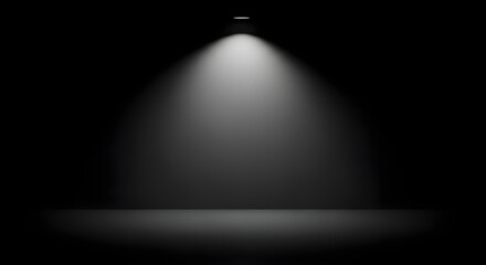 Bright spotlight illuminating an empty dark stage or studio room, creating a dramatic focal point for presentation or display.