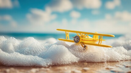 Tiny yellow biplane toy rests on ocean waves