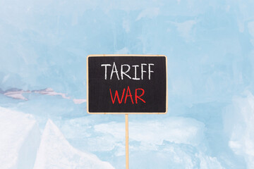 Trade tariff war symbol. Concept word Tariff war on beautiful black blackboard. Beautiful Baikal...