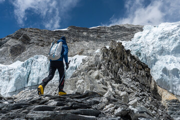 A male climber is approaching the fixed ropes on Island Peak during an expedition in Nepal. © Sanna Raistakka