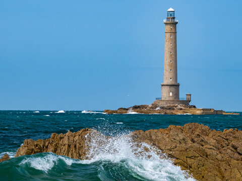 Waves hitting the rock on the Atlantic Ocean at the Phare de Goury in the Cotentin Coast in Normandy, France 