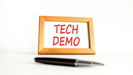 Tech demo symbol. Concept word Tech demo on beautiful wooden picture frame. Black pen. Beautiful...