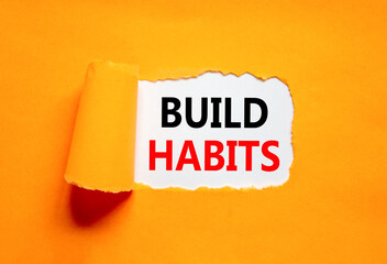 Build habits symbol. Concept word Build habits on beautiful white paper. Beautiful orange paper...