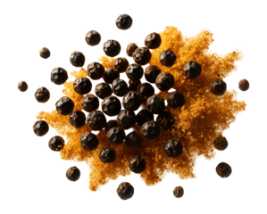 Explosive burst of black peppercorns and golden ground spices suspended mid-air.