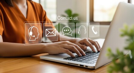 Professional customer support concept with businesswoman typing on laptop, displaying floating contact icons including email, chat, headset, and phone in modern office