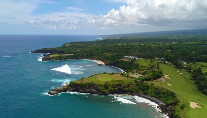 A sweeping vista of a tropical coastline featuring a picturesque bay, lush greenery, and a golf course, showcasing the natural beauty of a remote island paradise.