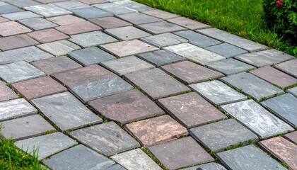 A close-up view of a meticulously laid stone pavement, showcasing a variety of muted gray, brown, and pink hues.  The pattern of the rectangular paving stones creates an interesting visual texture.