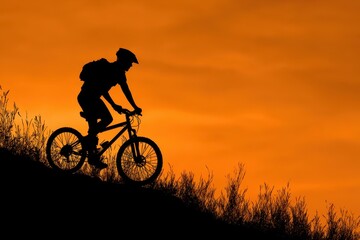 Obraz premium Bike Marathon. Silhouette of Bicyclist Riding Mountain Bike on Sunset Hills Trail
