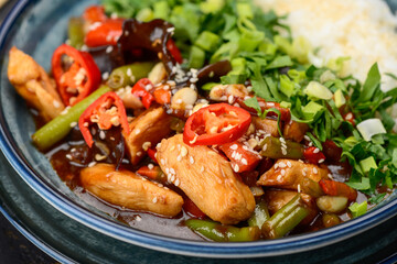 rice with chicken and cherry tomatoes in a plate macro photo