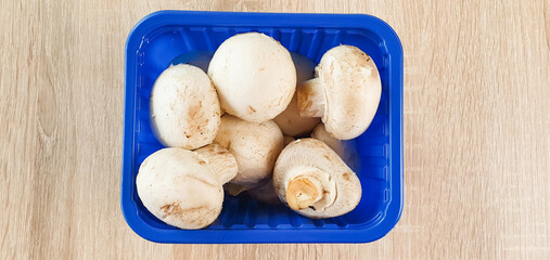 Packaging of fresh, natural champignons. White champignons, mushrooms, harvest.