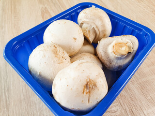 Packaging of fresh, natural champignons. White champignons, mushrooms, harvest.