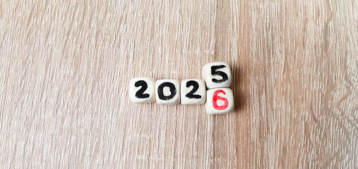 2025-2026 on wooden cubes, change of year, goal, business planning.