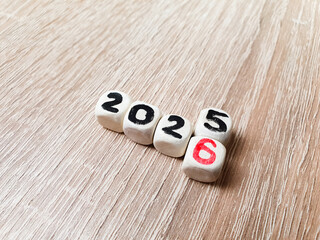 2025-2026 on wooden cubes, change of year, goal, business planning.