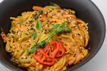 noodles with microgreens and pepper on a white background macro