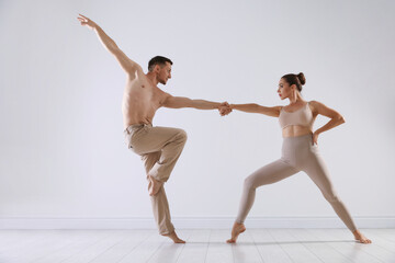 Couple of professional dancers training in studio