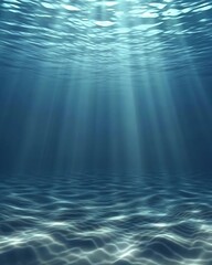 Deep blue ocean water with shimmering sunlight rays and sandy seabed underwater