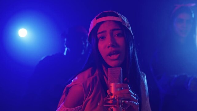 Young singer performing live with her crew in slow motion