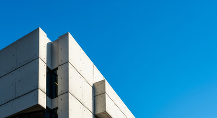 Brutalist Concrete Structure Set Against a Deep, Cloudless Cobalt Blue Sky in a Graphic Composition