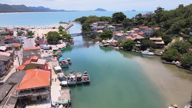 Aerial view of Barra da Lagoa canal with fishing boats and fishing community in Florian&oacute;polis, Santa Catarina, Brazil, Lagoa da Conceicao estuary