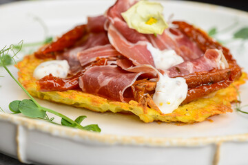 omelet with ham and herbs in a white plate macro photo