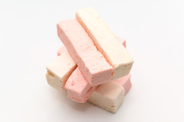 Rectangular white and pink marshmallow. On a white background. Sweet dessert.
