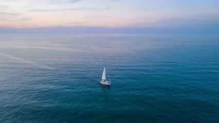Sailboat Sailing on Calm Sea at Sunset, Aerial View