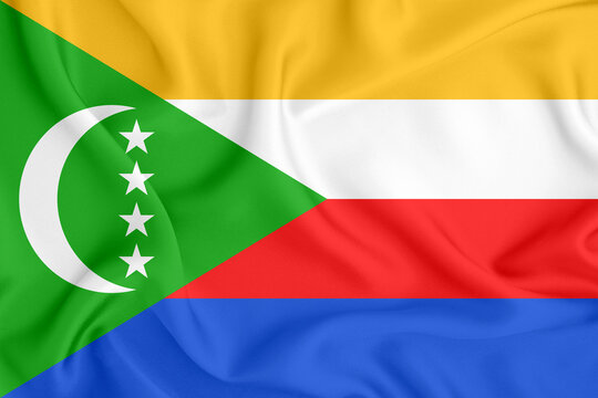 flag of the Union of the Comoros with a crescent moon and stars on a satin fabric with folds and shadows - Powered by Adobe