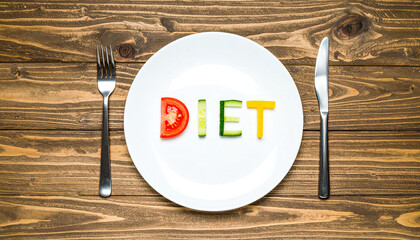 Word diet made of vegetables on white plate and rustic wood table