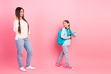 Mother and daughter waving each other goodbye in pink background