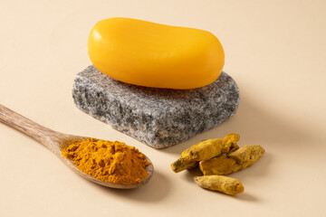 Handmade turmeric soap on stone. Organic skincare product perfect for wellness, beauty, and organic body care concepts. Close up.